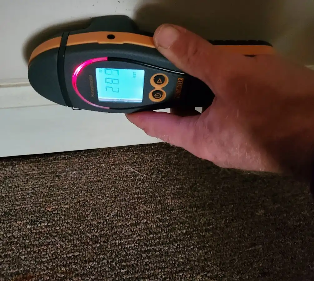 Moisture detection at baseboard during Storm Damage Restoration in Le Ray